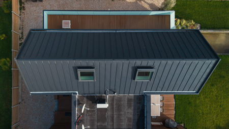 Couverture en zinc GRANUM EXTRA basalte sur une maison individuelle à Camiers Vue aérienne d'une couverture en zinc GRANUM EXTRA basalte sur une maison individuelle dans le nord de la Fance